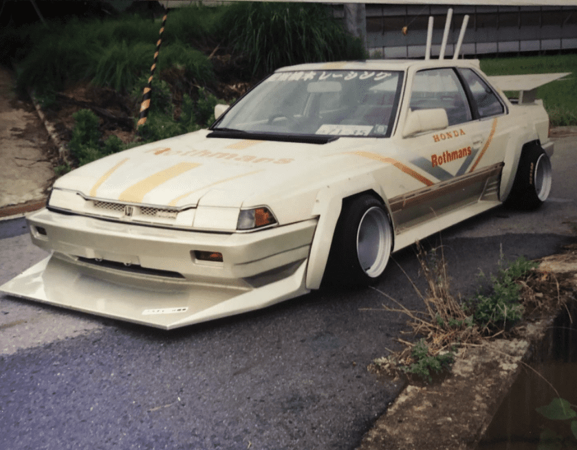 white and gold car with long front spoiler