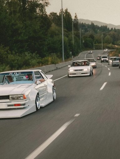 Group of kaido racer cars driving on the highway as a group