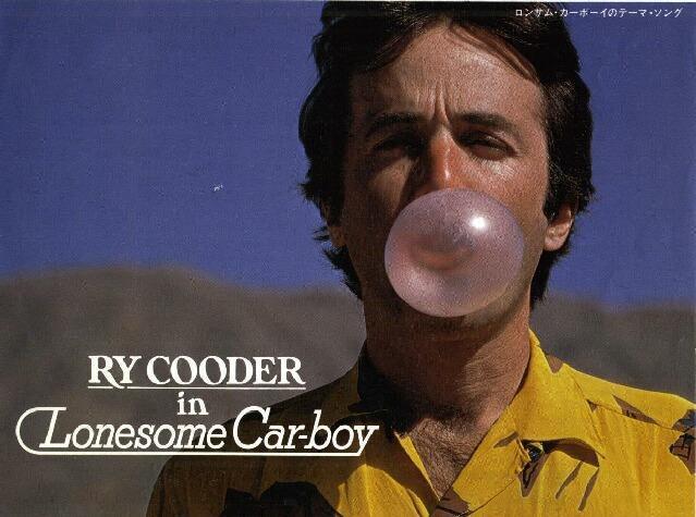 Man blowing bubble gum with text 'Ry Cooder in Lonesome Car-boy' in front and Japanese text at top right