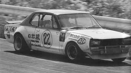 Vintage race car with number 22, featuring Mobil, STP, and Japanese Nihon Radiator logos, speeding on a track.