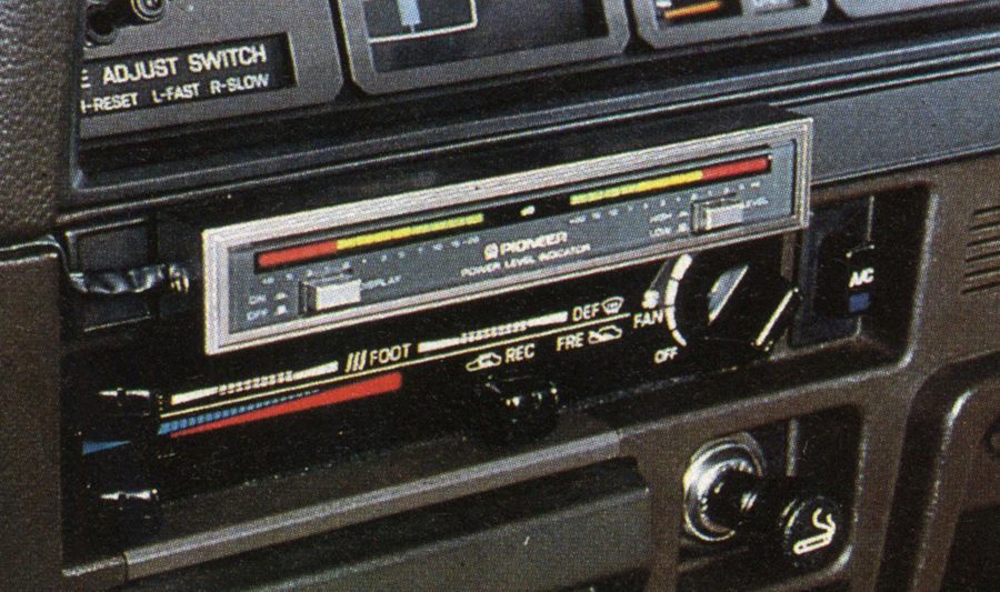 Close-up of a car dashboard showing an old Pioneer radio, air conditioning controls, and an adjust switch.