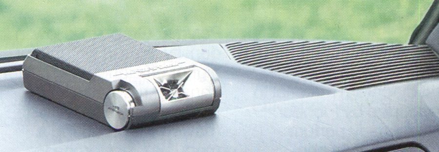 Alt text: Compact electronic device with Japanese inscriptions on a car dashboard.