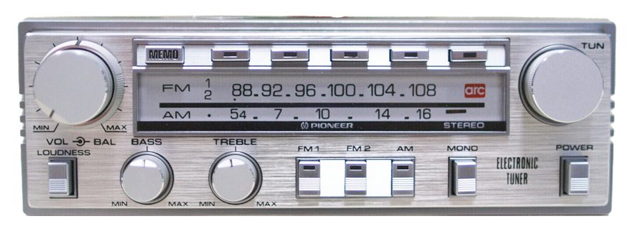 Vintage Pioneer car stereo with electronic tuner, displaying FM and AM radio stations. Features bass, treble, volume controls.