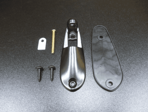Door stopper components including screws, bracket, and stopper on a black surface, ideal for home improvement projects.