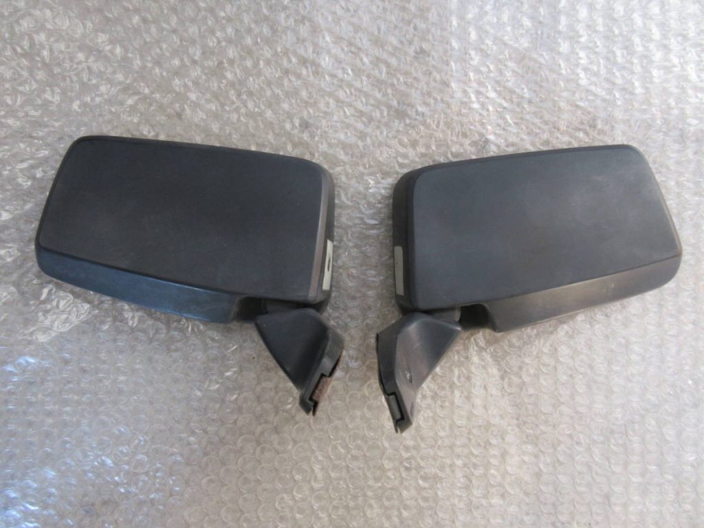 Two black car side mirrors on bubble wrap surface.