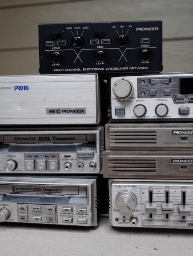 Vintage Pioneer audio equipment including a stereo main amplifier, component systems, and an electronic crossover network.