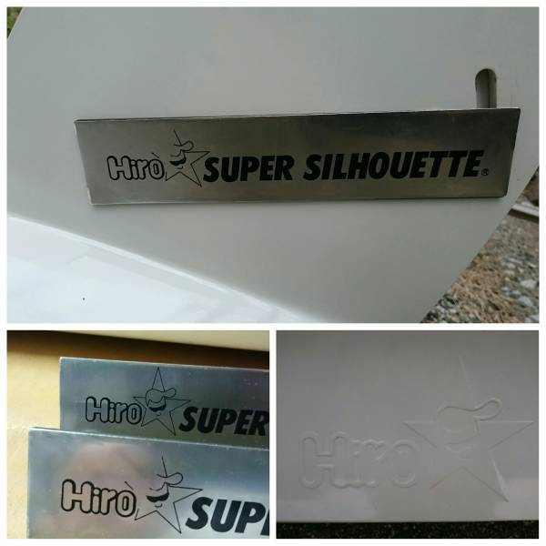 Close-up of Hiro Super Silhouette metal plaques on white background, showcasing brand logo and embossed design.