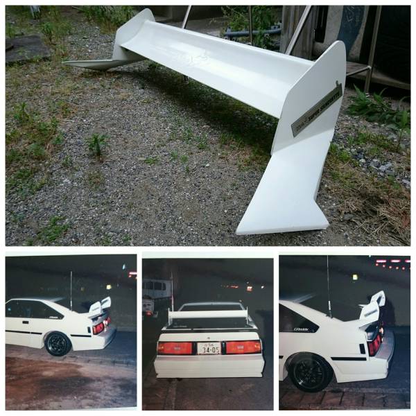 Large white GT wing spoiler and its installation on a white sports car with black wheels and customized rear bumper.