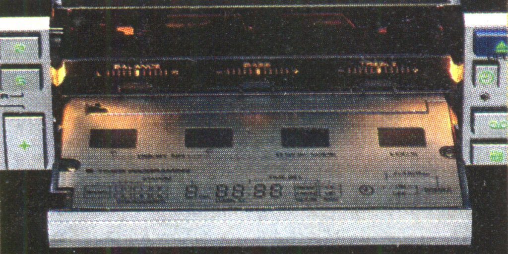 Close-up of an electronic device with Japanese text and digital display, possibly a stereo or audio equipment.