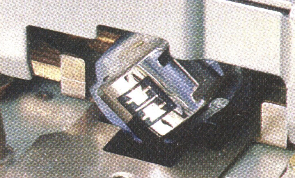 Close-up of a precision metal cutting tool, with the visible Japanese characters 精密 (precision) etched on the surface.