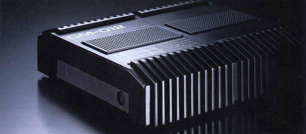 Vintage GM-012 computer hardware component, showing unique angular design and cooling vents in a dark, moody background.