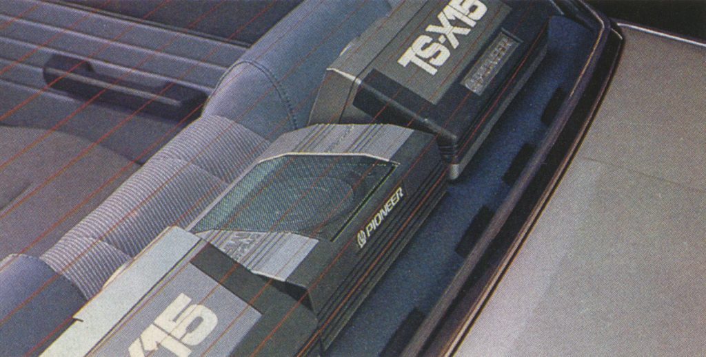 Vintage Pioneer car speakers, TS-X15 model, mounted on the rear deck of a vehicle.