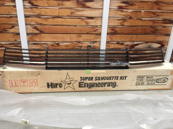 Hiro Engineering Super Silhouette Kit for Soarer Skyline in black, front mask grill on box with wooden background.