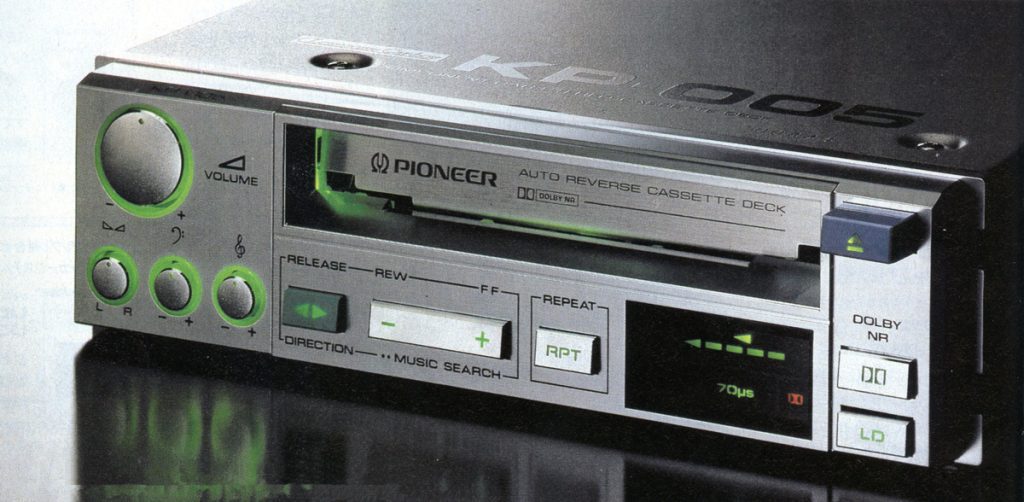 Vintage Pioneer KP-005 auto reverse cassette deck with Dolby NR and music search functions, featuring green-lit controls.