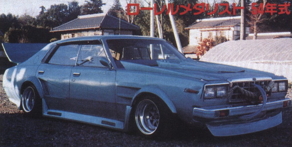 Customized vintage car, 1979 Nissan Laurel Medalist, with wide body kit and modifications in a rural setting.