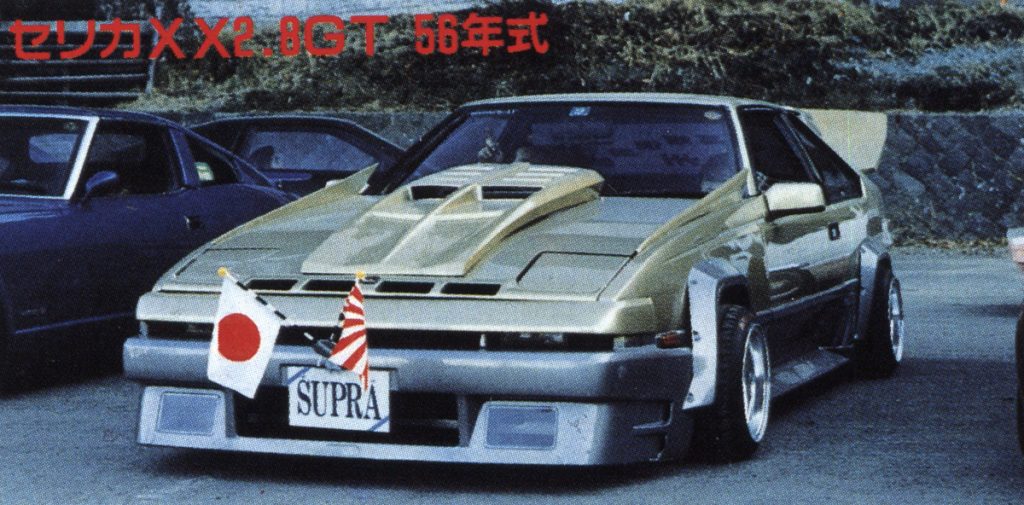 Modified Toyota Celica XX 2.8GT 1981 with Japanese flags and custom hood scoop. Text in image reads Celica XX 2.8GT 1981 Model.
