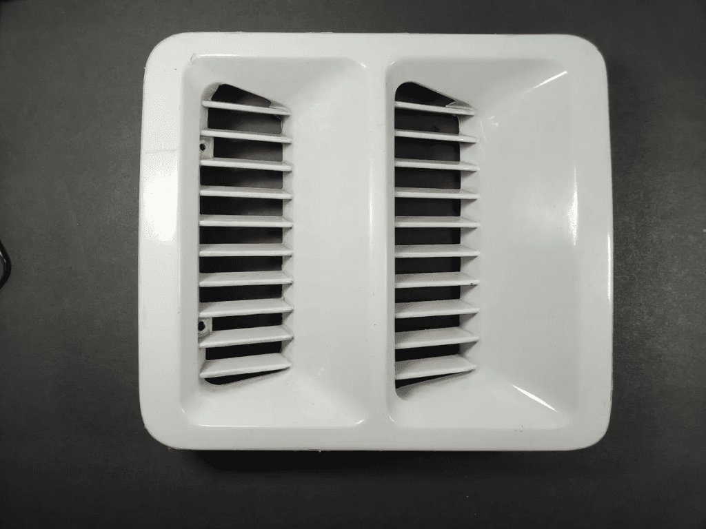 Rectangular white vent cover with two sets of parallel slats, displaying against a dark background.