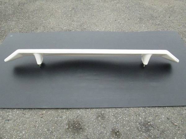 White car rear spoiler on black background, suitable for automotive enthusiasts and car customization.