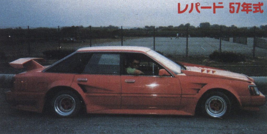 Vintage red Nissan Leopard on a street; Japanese text reads Leopard 57 year model, referring to 1982.