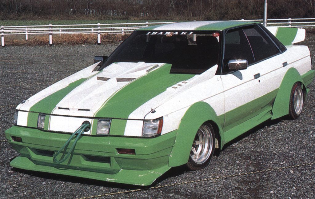 A modified white and green car with Ibaraki written on the windshield, featuring unique body kit and custom design.