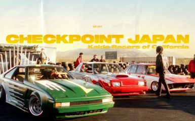 Custom Japanese sports cars and racers at Checkpoint Japan event in California with mountain backdrop.