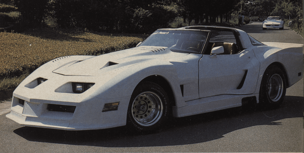 Vintage white sports car with modified body kit on a tree-lined road. Japanese text on windshield reads ボンドカーズ (Bond Cars).