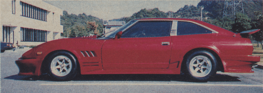 A sleek, red sports car parked outdoors on a sunny day, showcasing its streamlined design and stylish bodywork.