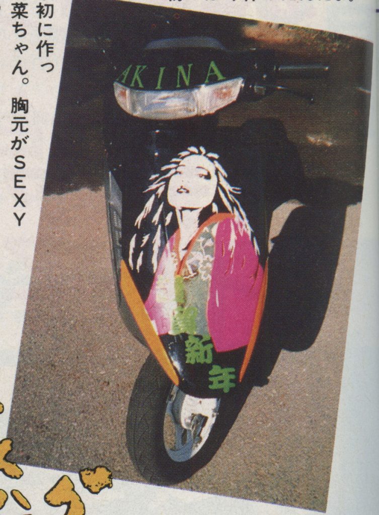 Customized scooter with anime-style artwork on the front panel, featuring a character with flowing hair and a colorful outfit.