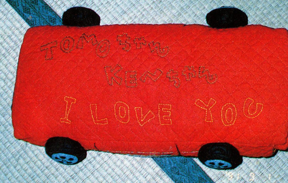 Red quilted fabric toy car with embroidered text: I LOVE YOU and TOMOちゃん KENちゃん.