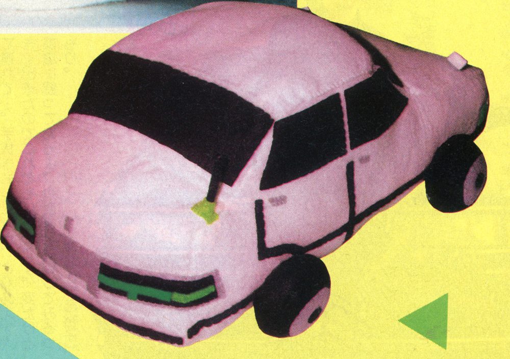 Toy car plush with a pink body and black windows on a yellow background.