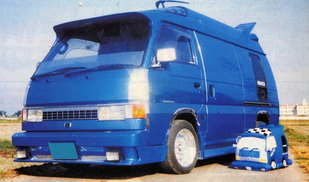 Blue custom van and matching plush toy on a road, with 風呂 seen on the van, meaning bath in English.