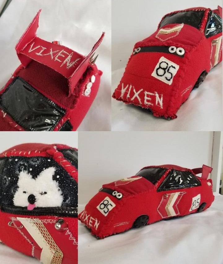 Handcrafted red fabric car with VIXEN and number 85 stitched, featuring a cartoon dog. Unique plush design.