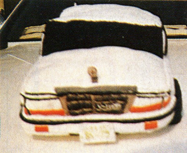 Plush toy car with a detailed front grill and Japanese text on the license plate, resembling a classic sedan.