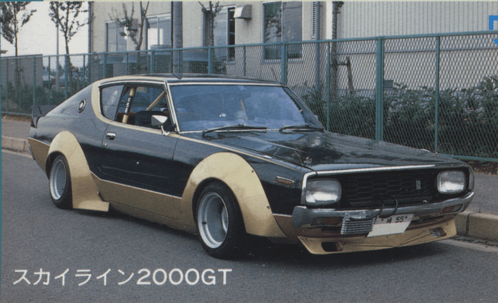 Vintage black and gold classic 1970s Japanese sports car parked on a street.