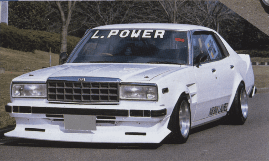 Customized white vintage car with L. Power on windshield, showcasing retro design and sleek modifications.