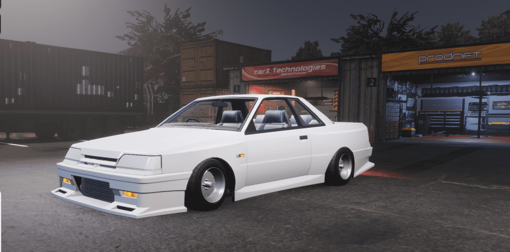 Customized white classic car parked outside a garage at night.