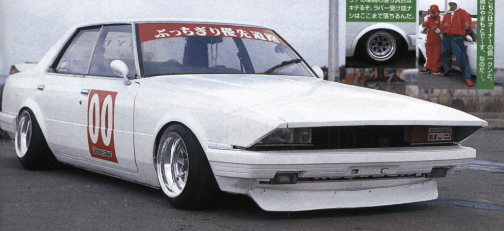 Vintage white racing car with number 00, sleek body design, Bridgestone tires, and Japanese decals on windshield.