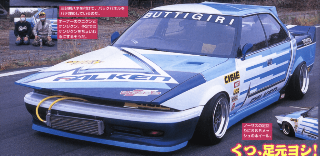 Modified Toyota sports car with custom graphics and body kit, featuring Falken and Cibie branding on a track.
