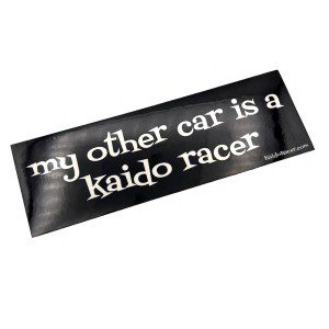 Bumper sticker with text my other car is a kaido racer in white on black background.