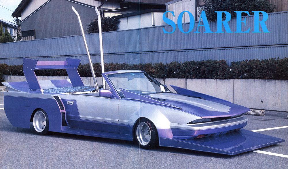 Futuristic purple modified car with unique design elements, parked on a street, labeled SOARER.