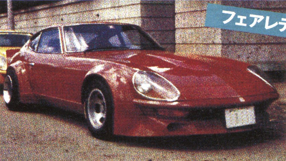 Red vintage sports car parked outside a building, showcasing classic design and sleek curves.