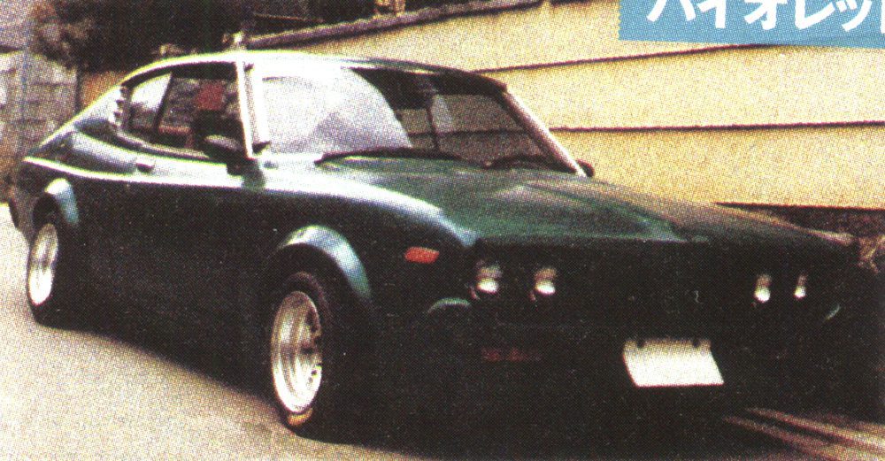 Vintage dark green sports car parked on a city street, showcasing classic design and sleek curves.
