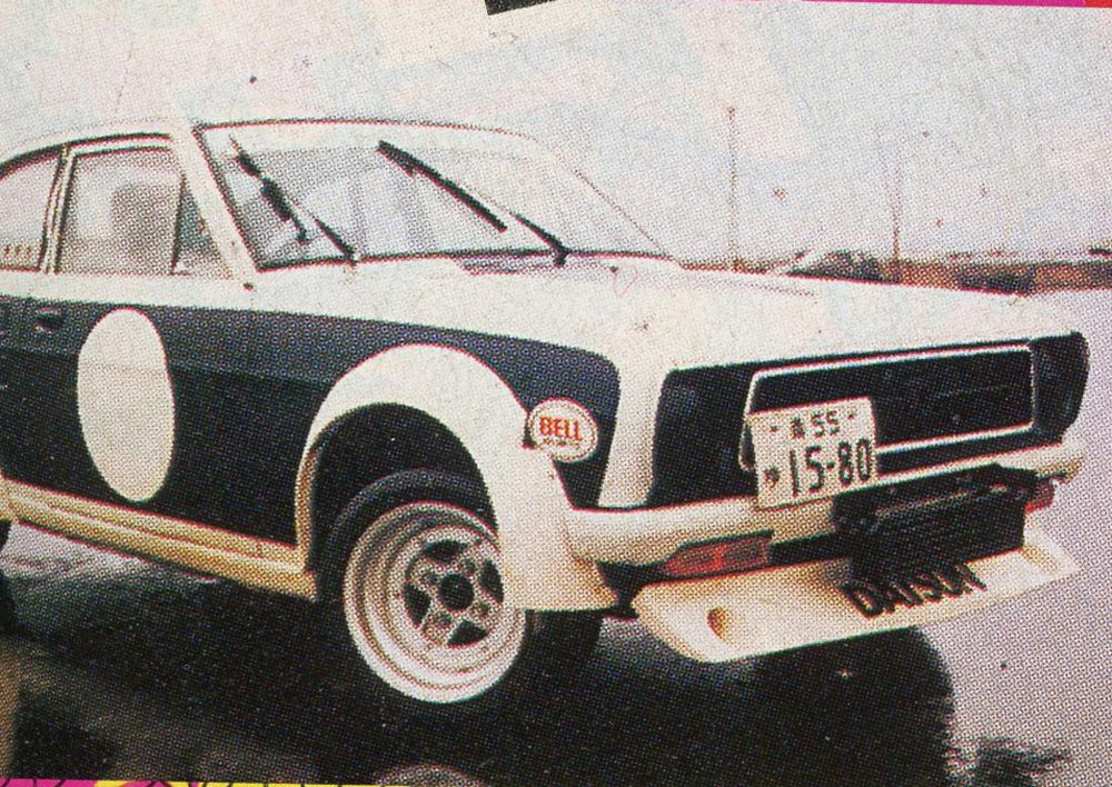 Vintage Nissan car with racing decals and Japanese license plate on a wet road. Classic design from the late 20th century.