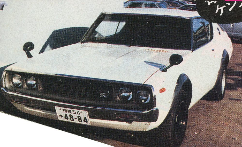 Vintage white sports car with retro design and distinctive front bumper parking in sunlight.