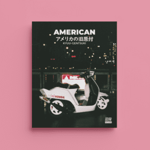 Book titled American with a pink background, featuring a vintage scooter at night with city lights.
