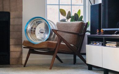 Paul Selig Z chair with SSR MK1 wheel decor beside a modern TV stand in cozy living room.