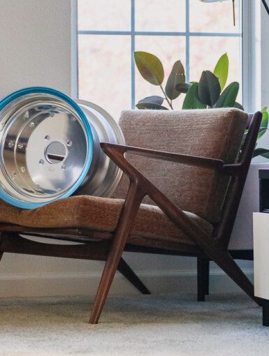 Paul Selig Z chair with SSR MK1 wheel decor beside a modern TV stand in cozy living room.