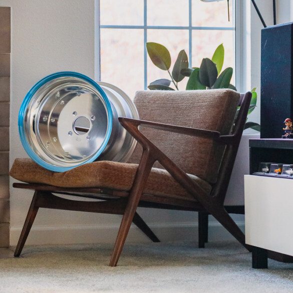 Paul Selig Z chair with SSR MK1 wheel decor beside a modern TV stand in cozy living room.