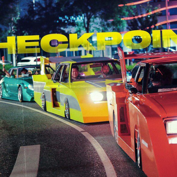 Cars lined up during a night street race event, with neon CHECKPOINT sign overhead.