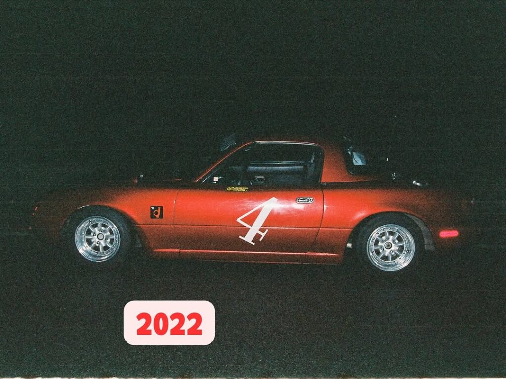 Red sports car with number 4 on the side, captured at night with a 2022 label in the foreground.